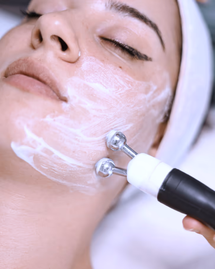 A facial treatment in progress at Marin Aesthetics: a microcurrent device worked gently across a client's cheek